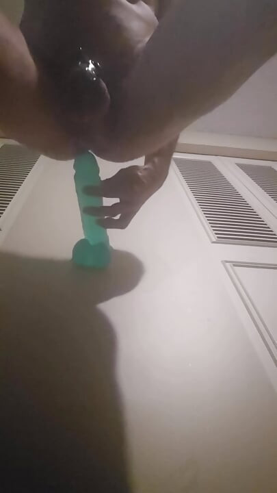 Caged sissy taking huge dildo