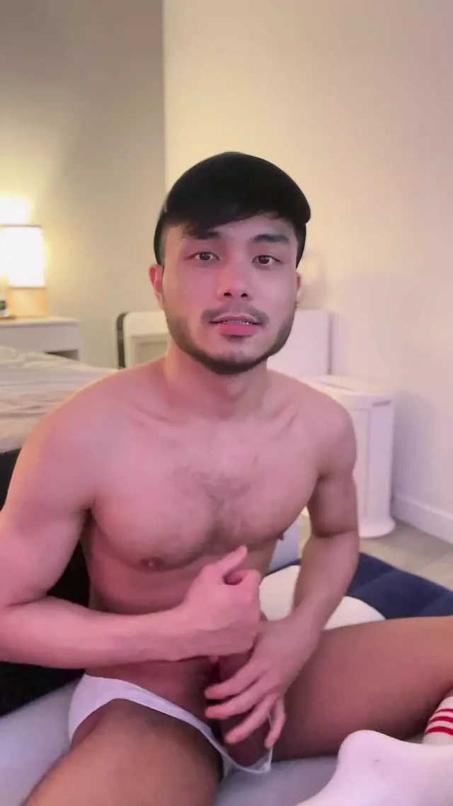 Asian boy stroking cock