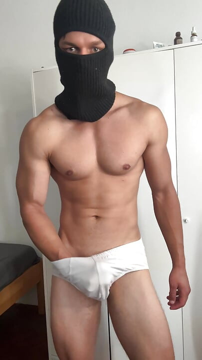 Young bodybuilder teasing in balaclava