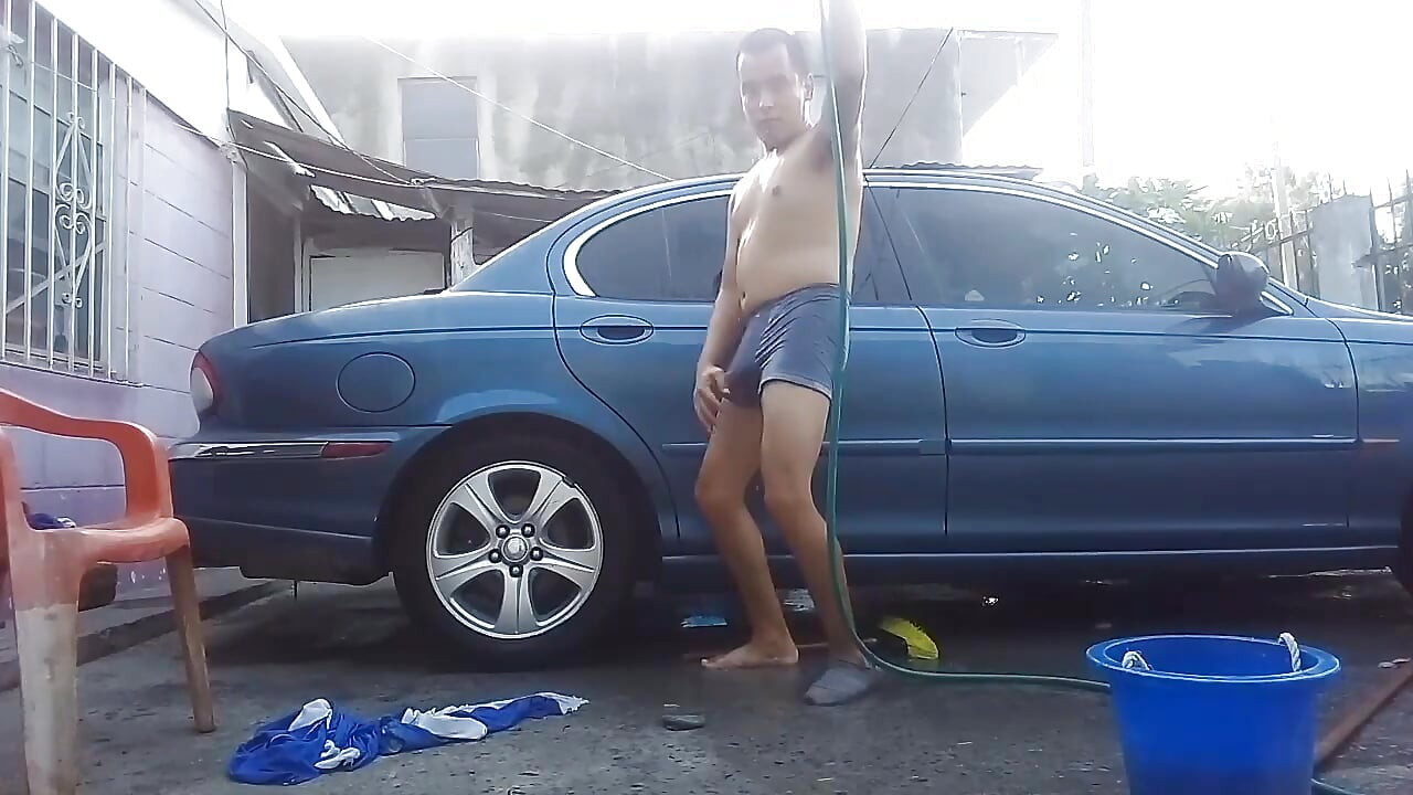 Jesus in gray boxer washing his jaguar car