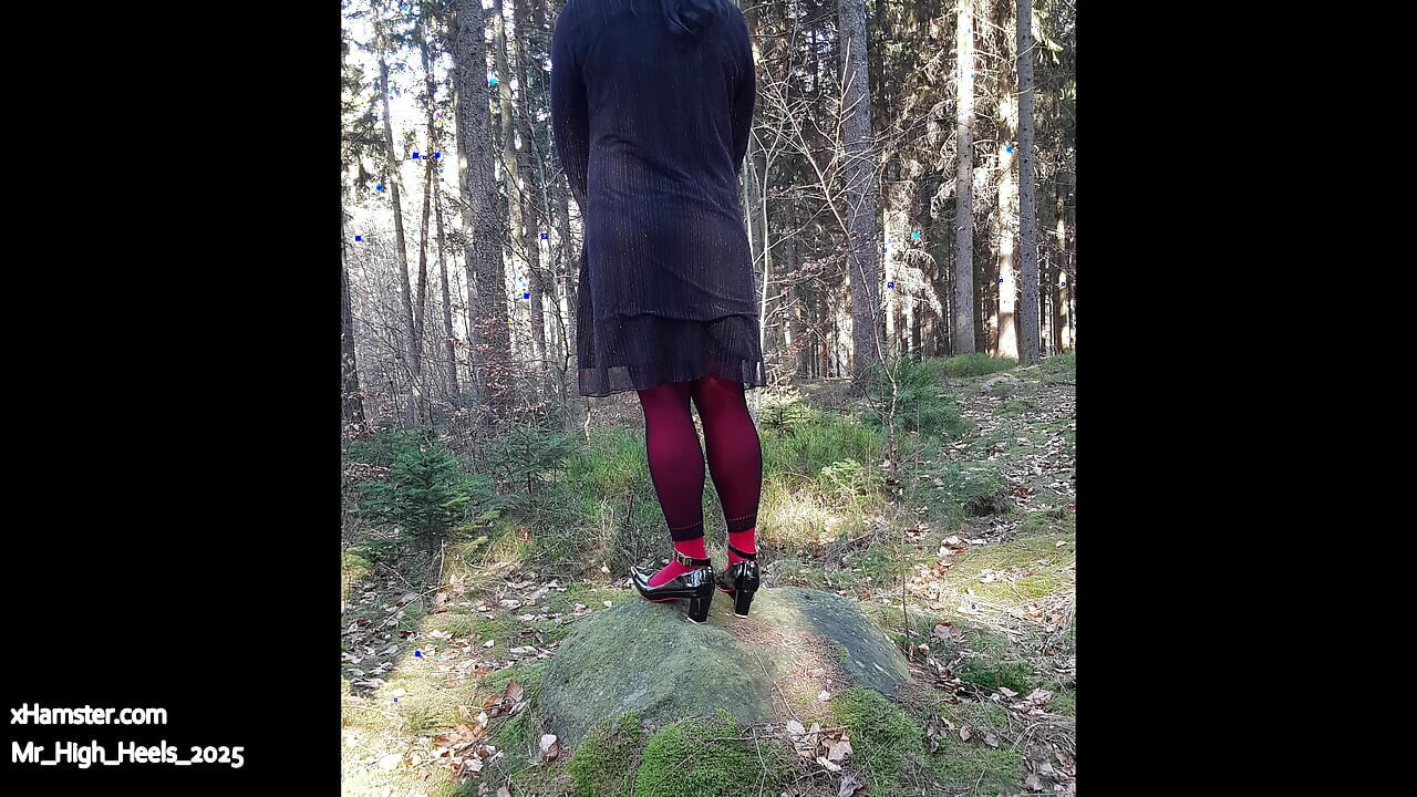 In the forest with high heels and red pants