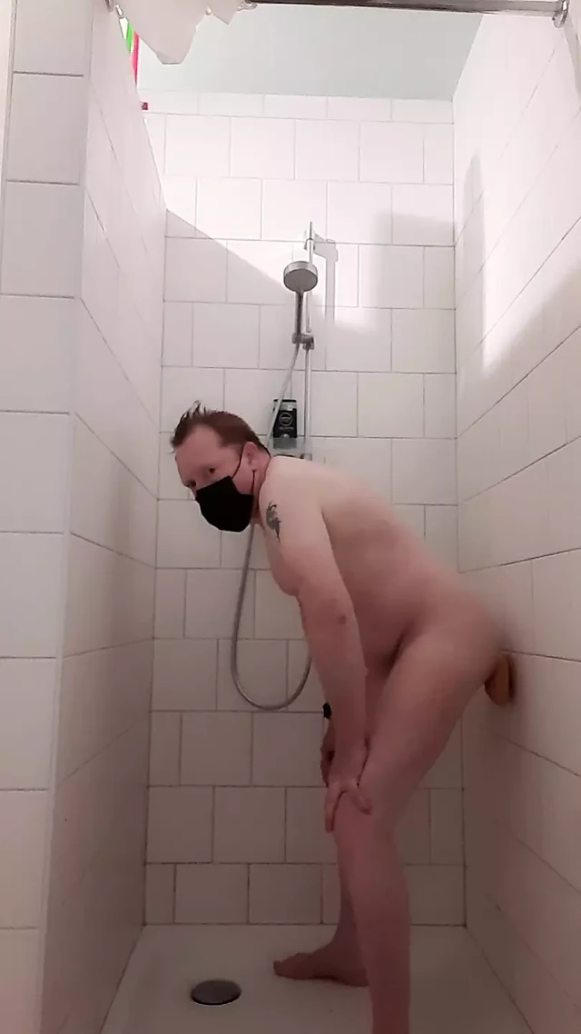 Ginger rides wall dildo and shoots cum