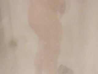 Una chica con un cuerpo de playboy a la que le gusta presumir en la ducha del hotel