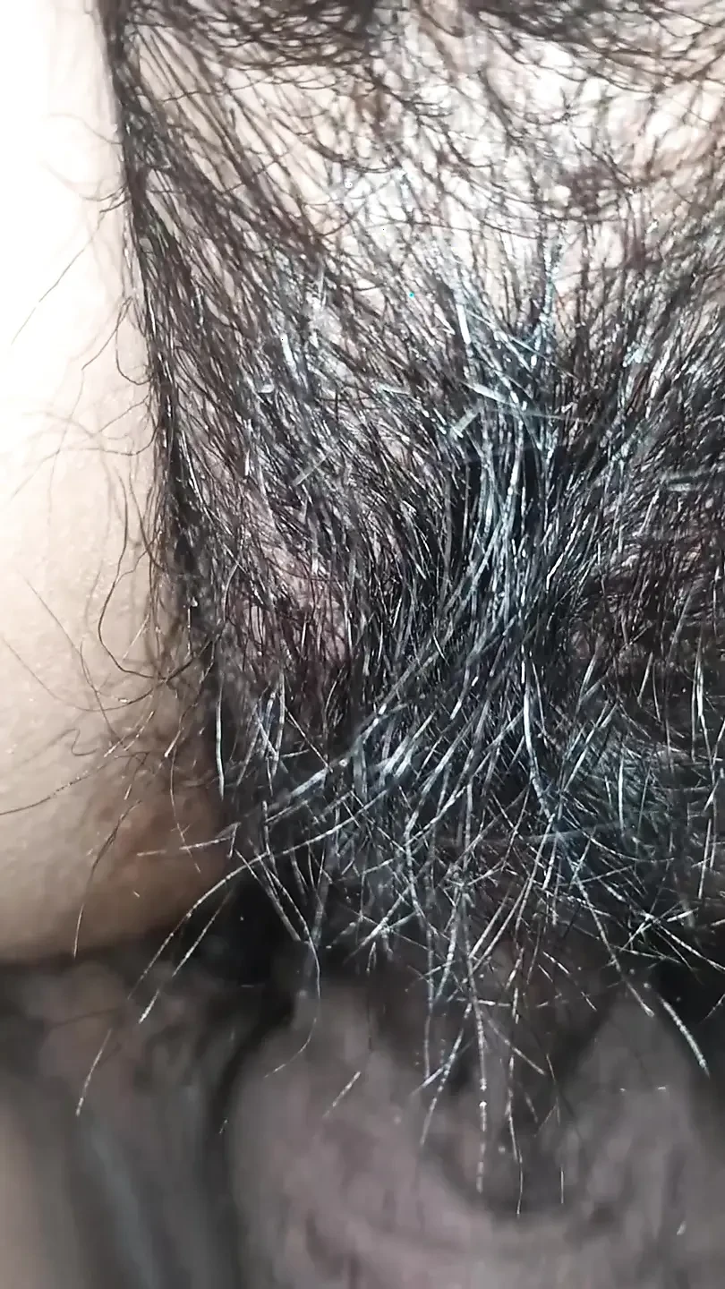 Close up view on a hairy and creamy pussy