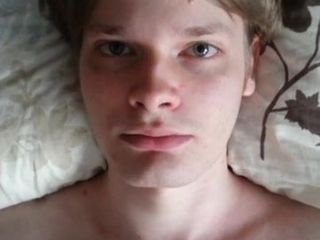 Masturbating in bed (only face visible)