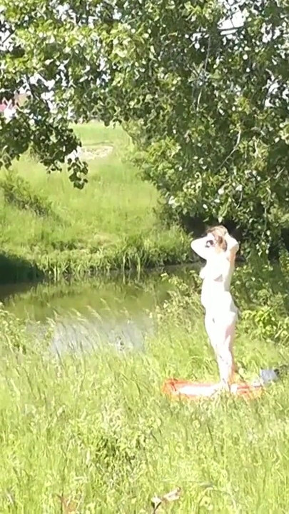 Thrilling moment from "Milf sexy woman sunbathing naked on river bank. Naked in public. Wild beach Nudist. Ass. Pussy."