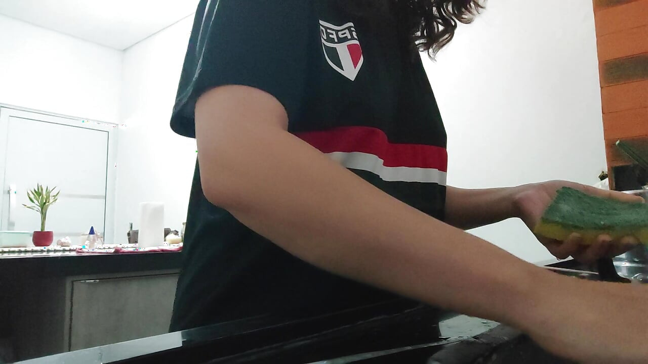 Woman teasing while washing dishes. She loves to transmit to the voyeurs on duty