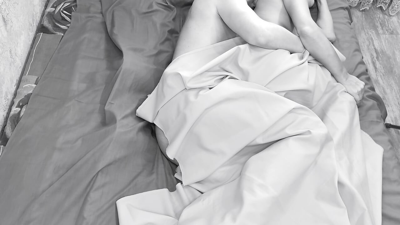 Couple caught on camera having sex in bed .