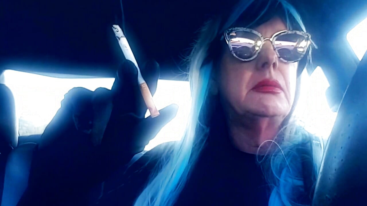 MATURE CD SMOKING & DRIVING WITH A MB100 CIGARETTE IN HER GLOVED HAND