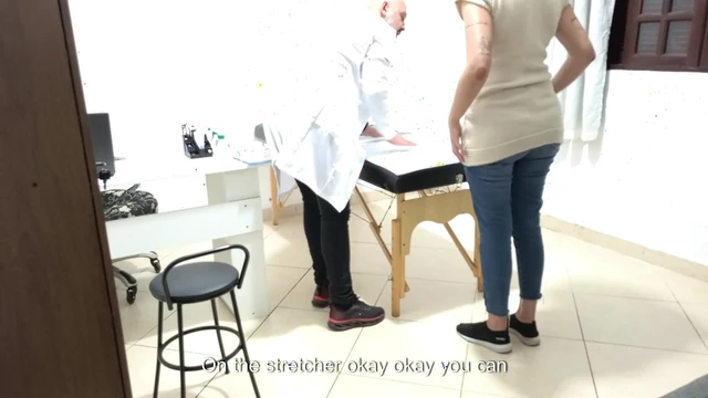 Proctologist performs anal exam on constipated patient.