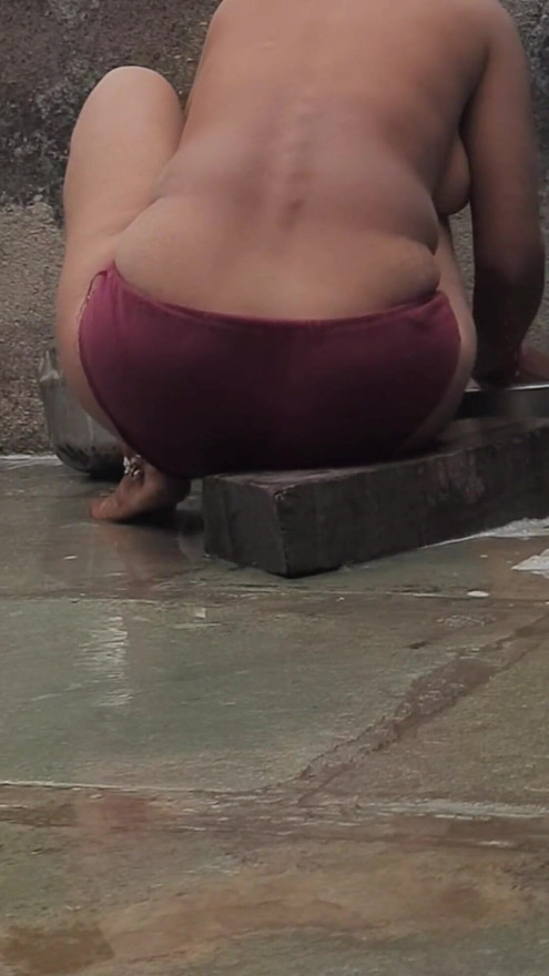 Desi Indian village bathroom in open courtyard wearing red tights bathing | Clip 2