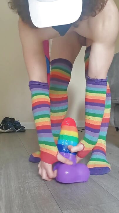 Femboy in Rainbow Stockings Riding Xxl Rainbow Banner