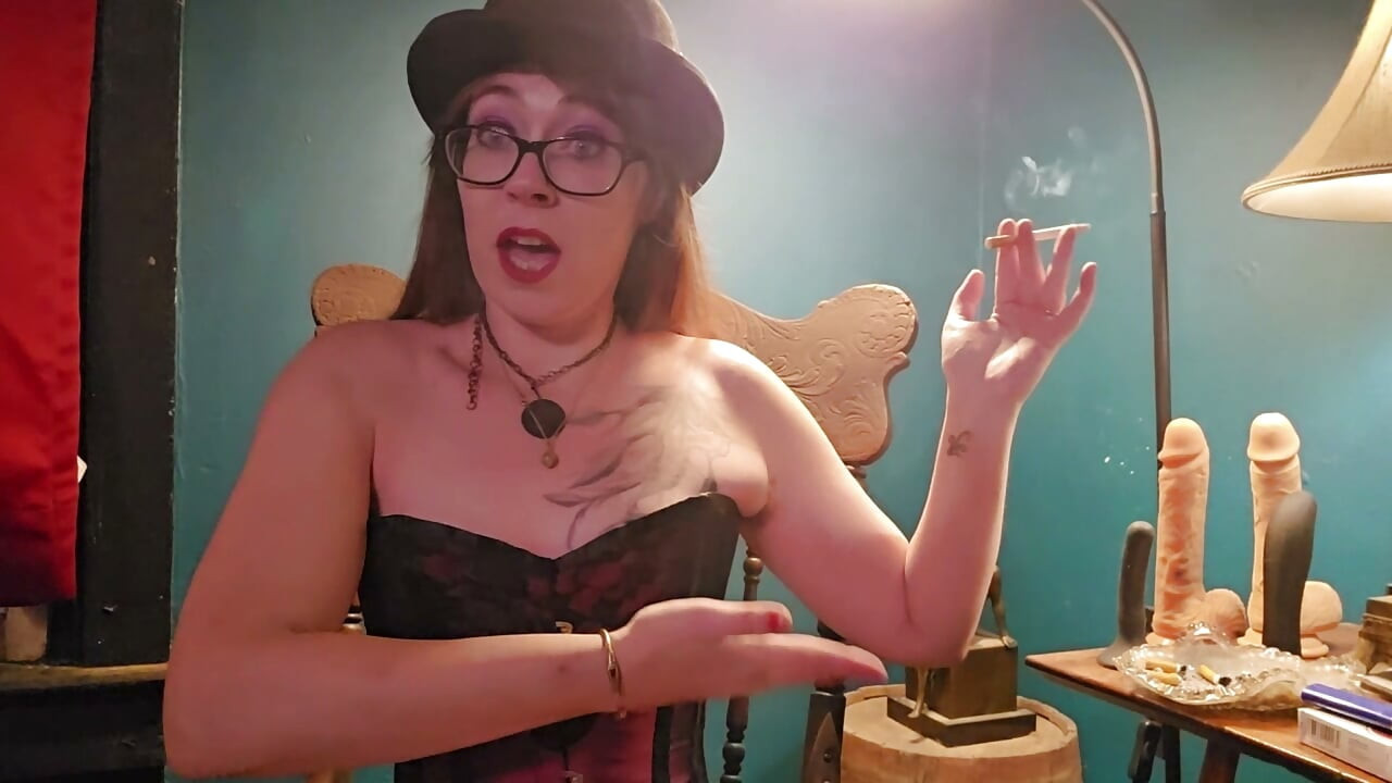 Smoking while wearing a purple corset, gloves, and a hat