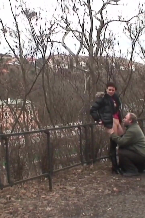 It's cold in the park and the young brunette with small natural tits gets warmed up by an old man and swallows all the cum