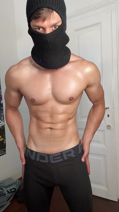 Masked hunk showing off his muscles