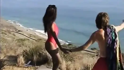 Black and white hairy pussy fucking in dogging position on the beach