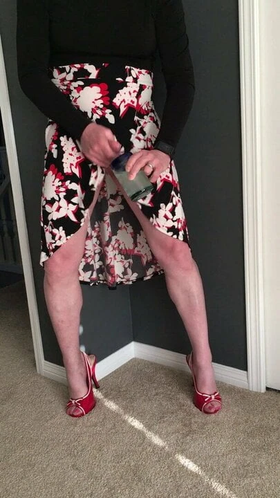 Stroking while dancing in flower dress and red heels.