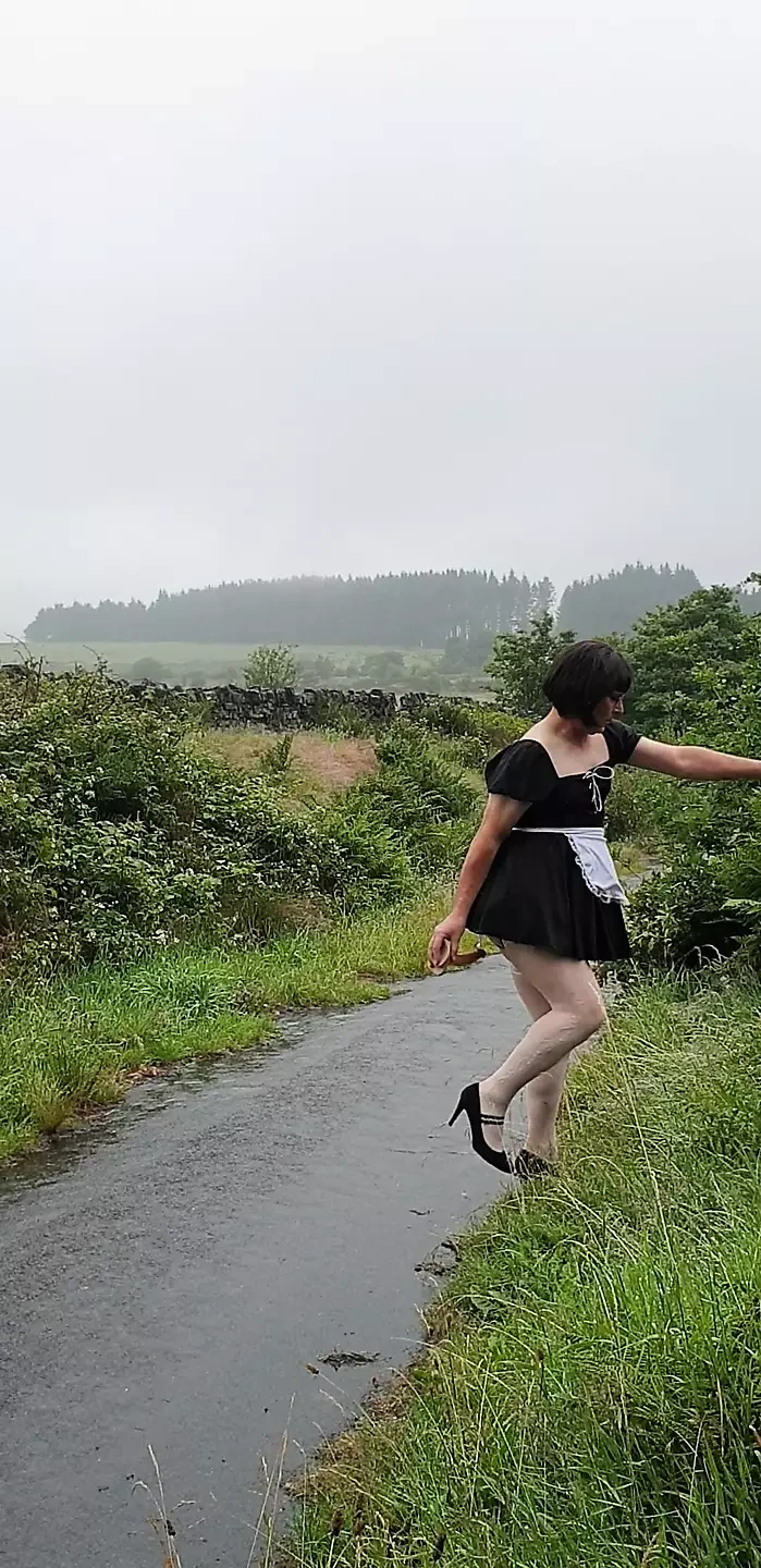 Crossdressing slut Maid on a public lane in the rain