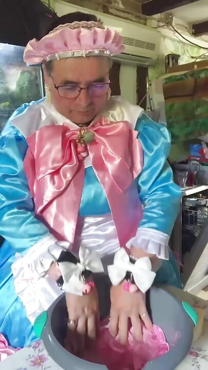 In a blue maid's outfit with pink bows to do the laundry.