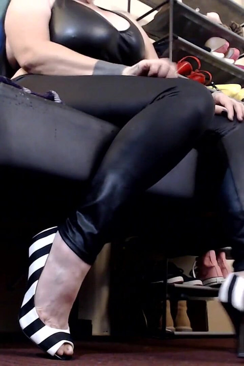 Worn high heels dangle shoe play