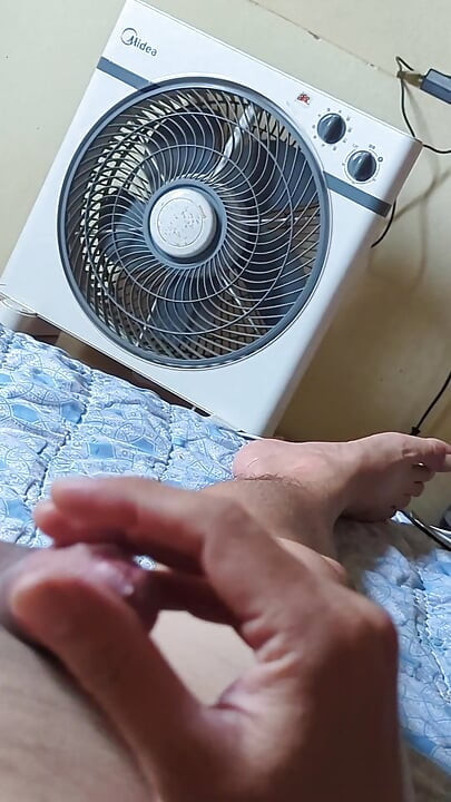 Young man with cock lying at home masturbating