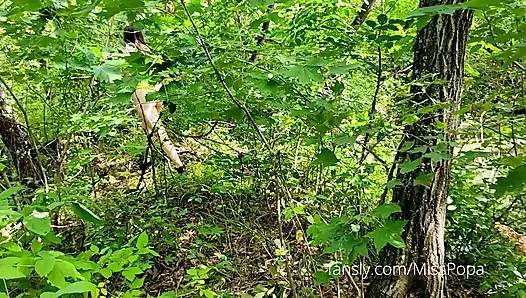 Young wife undresses and walks naked in a forest park
