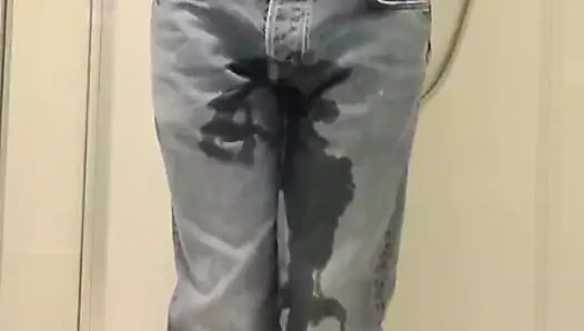 Guy pees in jeans