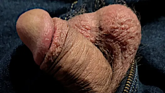 relaxed cock out of jeans up close