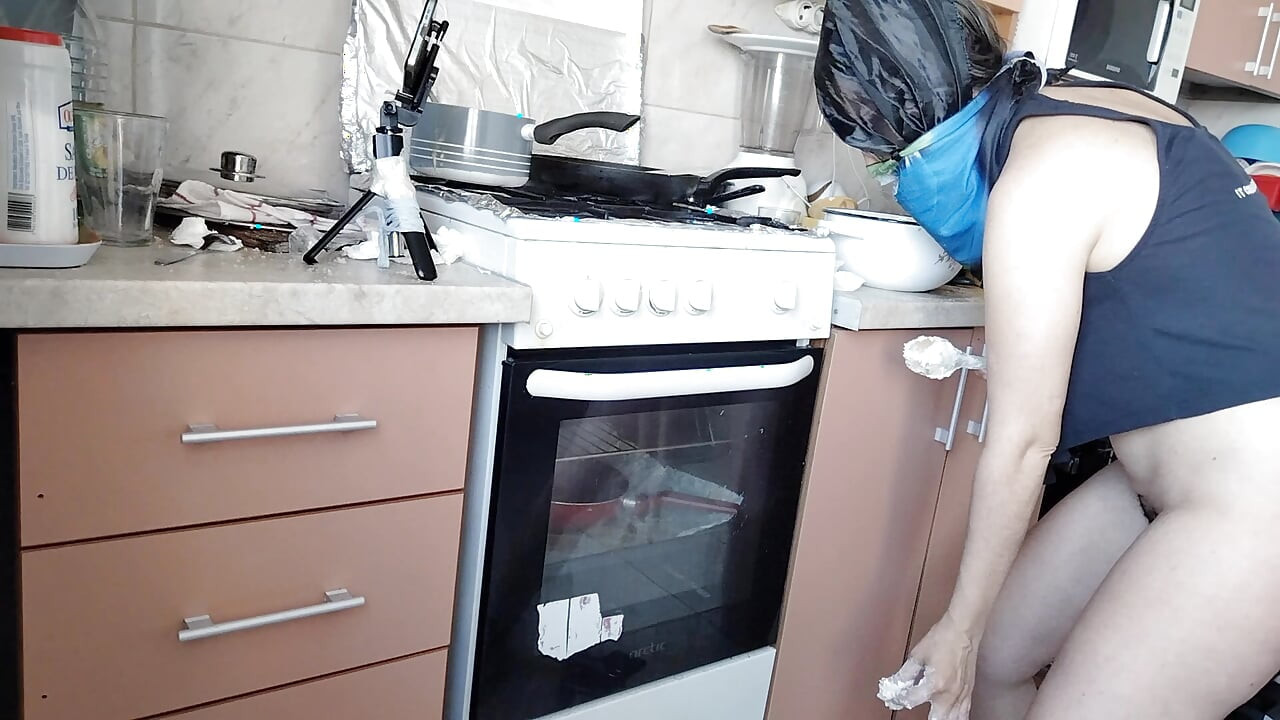 Sexy wife prepares lunch naked in the kitchen.
