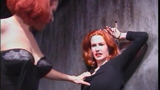 Curvy redhead shackled by lingere dominatrix