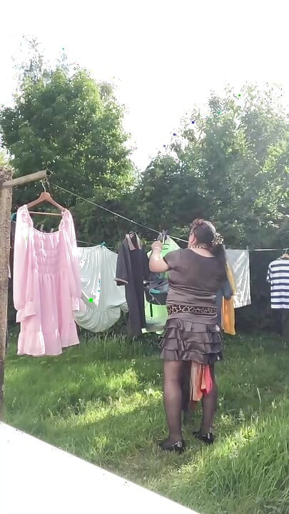 In an outfit with a charcoal colored ruffled dress to gather the laundry.