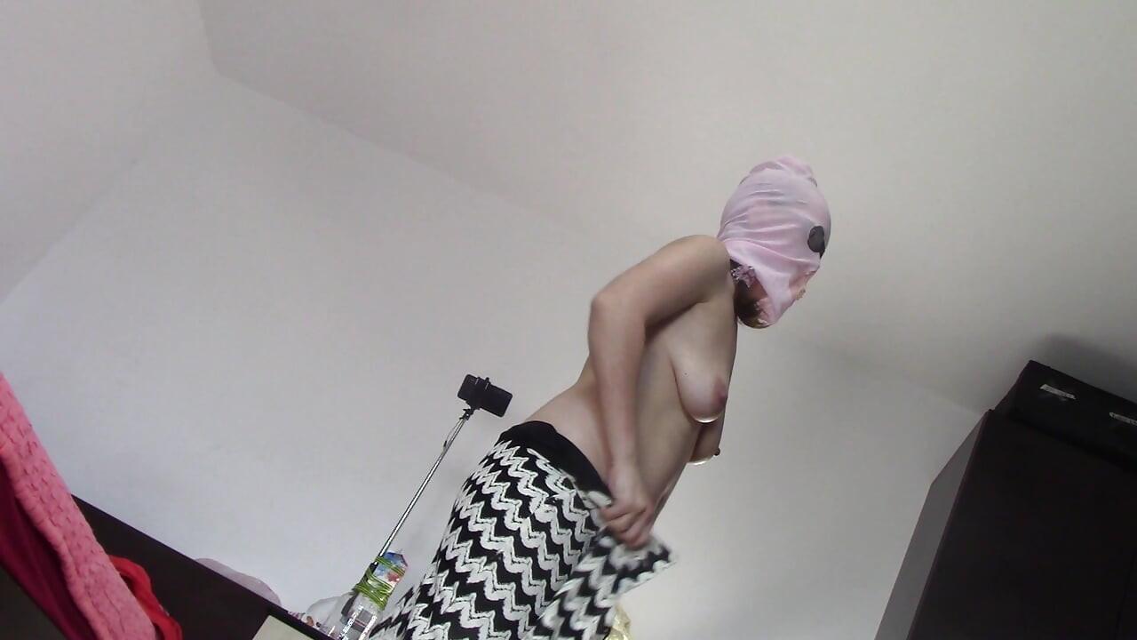 Amateur wife dancing naked at home. Amateur woman has fun trying on clothes and cutting them
