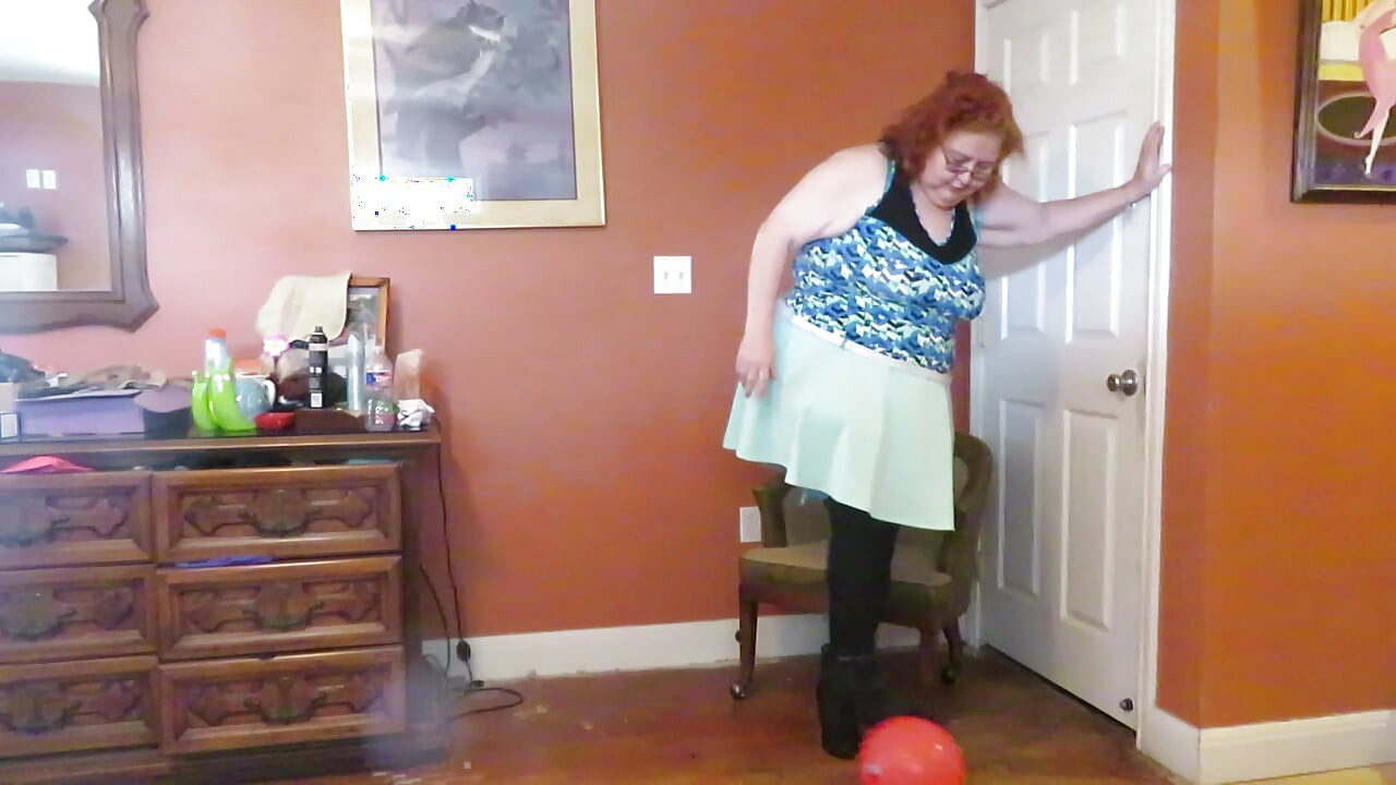 Nurse Vicki  plays with a rubber ball in a mini skirt, sexy stockings and high heel mini boots