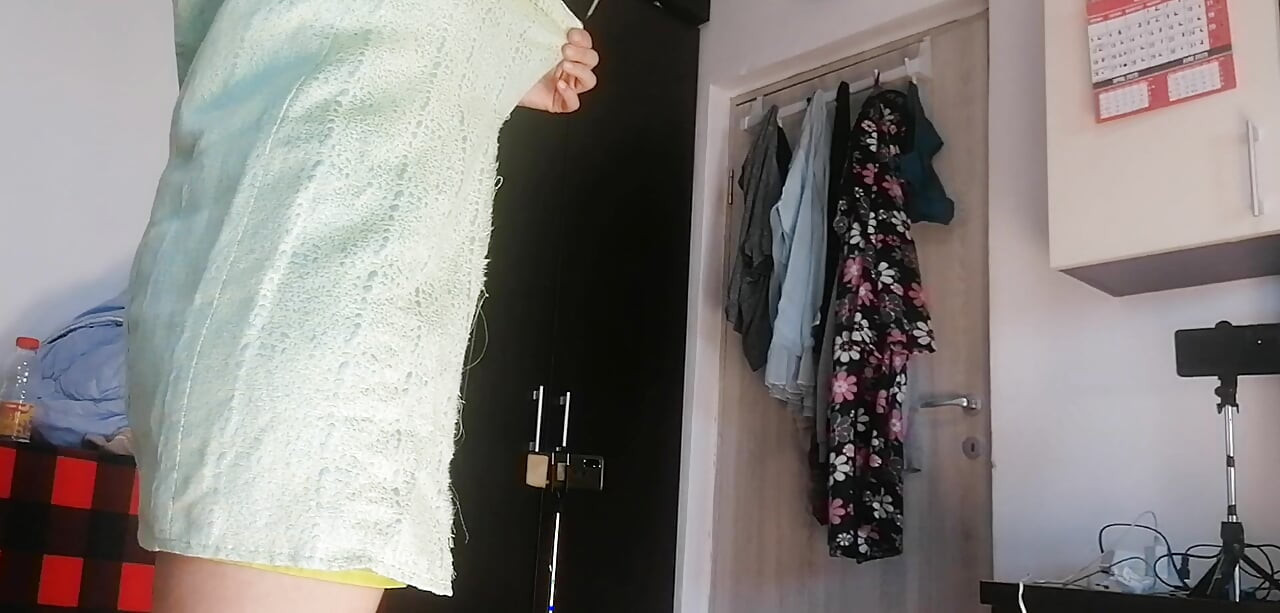 Amateur woman has fun trying on clothes and cutting them.