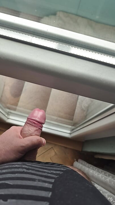 A thick and meaty Bulgarian cock is hard in front of the window