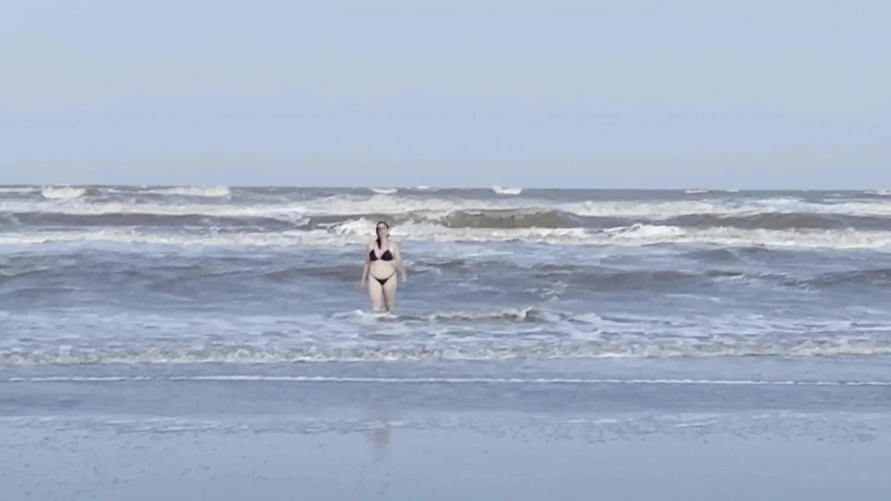 My neighbor loses her clothes at the beach.