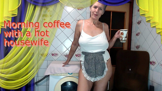 Morning coffee with a cheerful hot housewife chatting with fans over a cup of coffee while sitting on a washing machine.