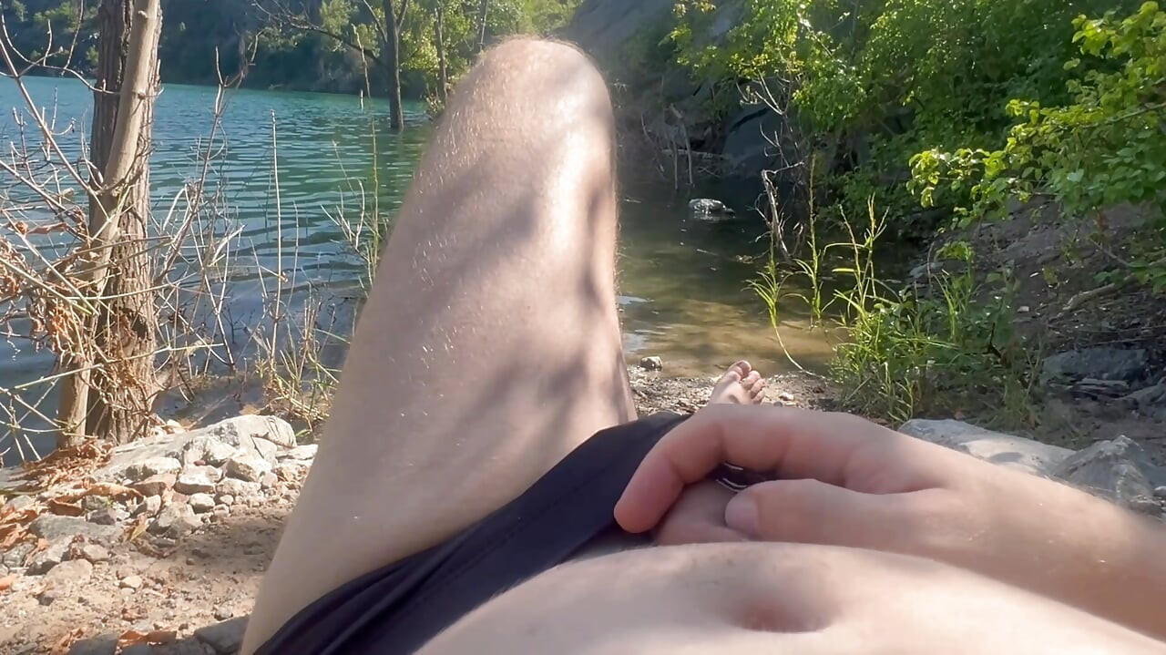 A guy on the beach decided to jerk off his cock while people were resting nearby and cumed from overexcitement