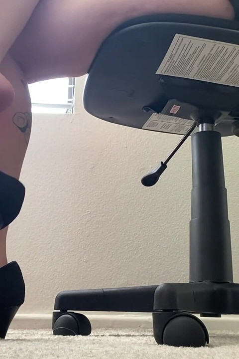 Secretary Dangles Black Heels at Desk