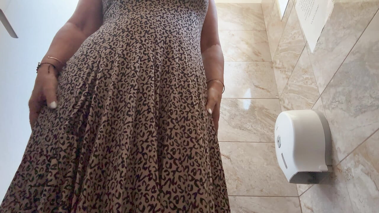 A horny mature MILF is very aroused and is rubbing her pussy in the public restroom at the office.
