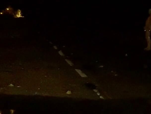 Naked in road and hiding the wrong side of road from safety when car passed