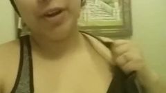 Busty Latina squeezing milk out of her tit at home