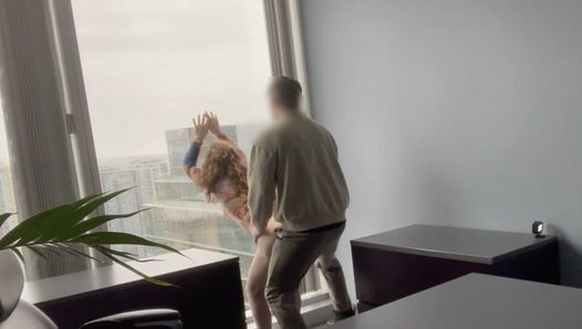 MILF boss fucked against her office window