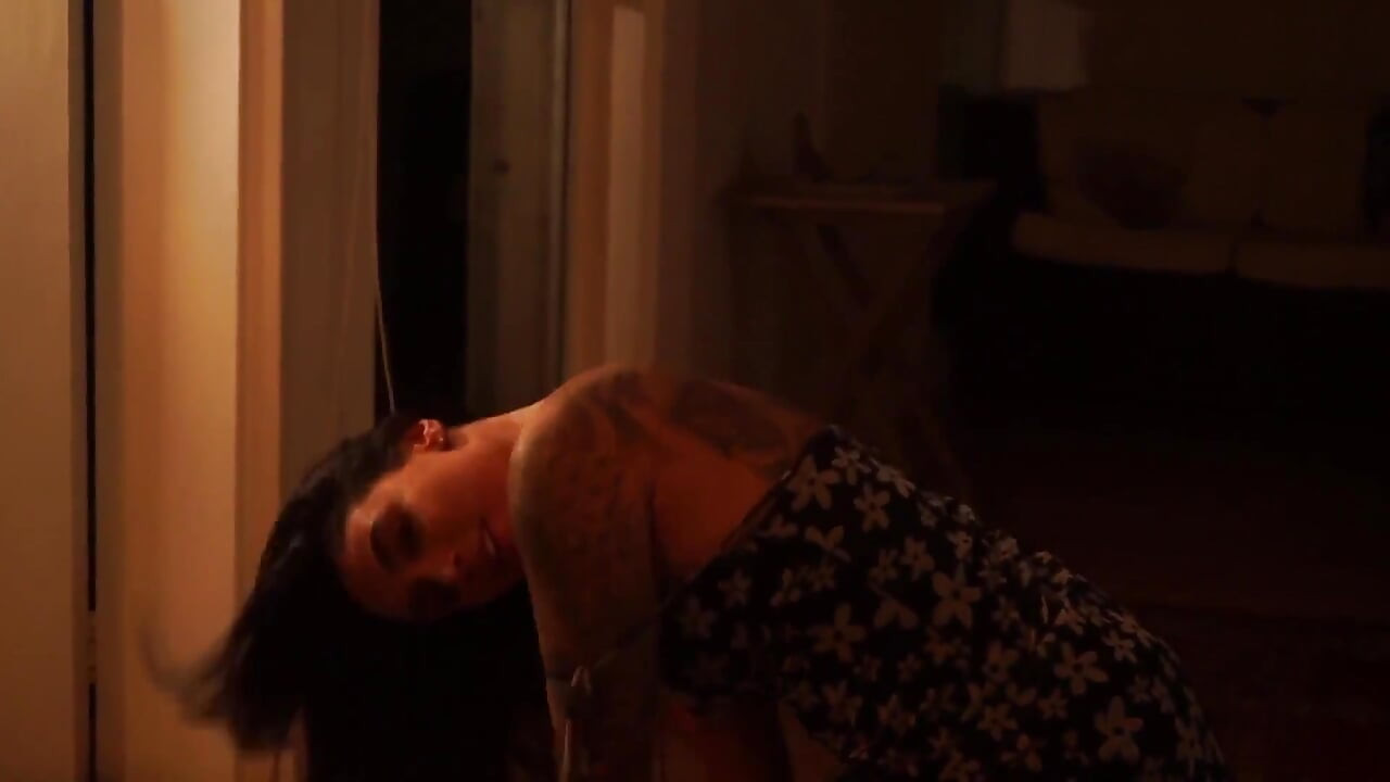 Sensual Latina Doing a Striptease in Low Light