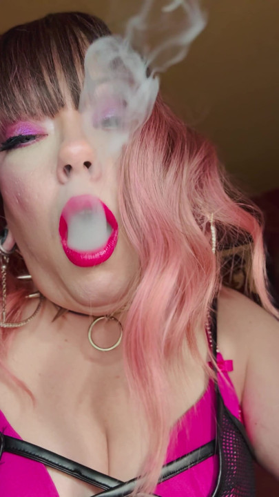 Miss Tina Snua Dressed In Pink Smokes A Richmond Superking Cigarette With Lots Of Dangling - OMI OME Snap Inhales Smoke Rings | Clip 1