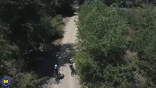 Two hot big breasted MILFs having a threesome with a toyboy in the open air