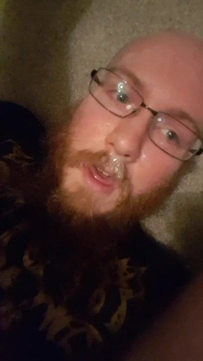 bearded boy cums all over his face