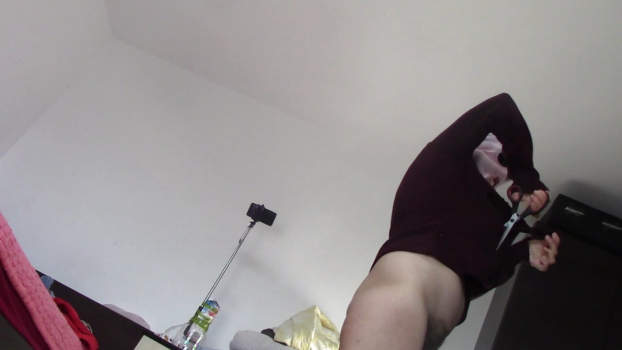 Amateur wife dancing naked at home. Amateur woman has fun trying on clothes and cutting them.