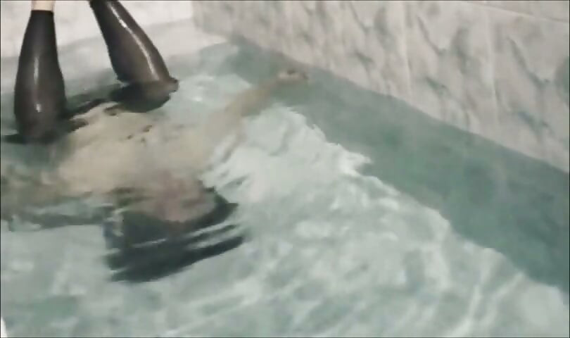 Sissy underwater attempting to perform autofellatio