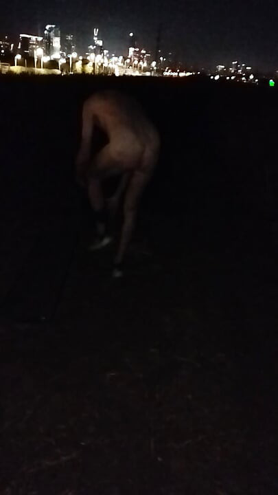 Naked walking on the hill along highway